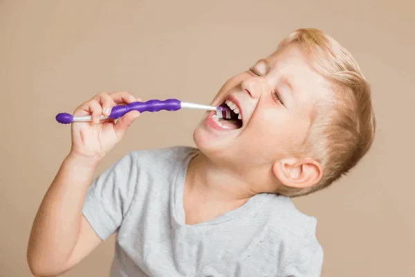 boy brushing his teeth - Markham dentists by 7 Days Dental