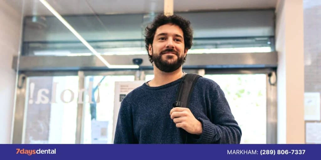 Smiling patient leaving a dental clinic feeling satisfied with their visit
