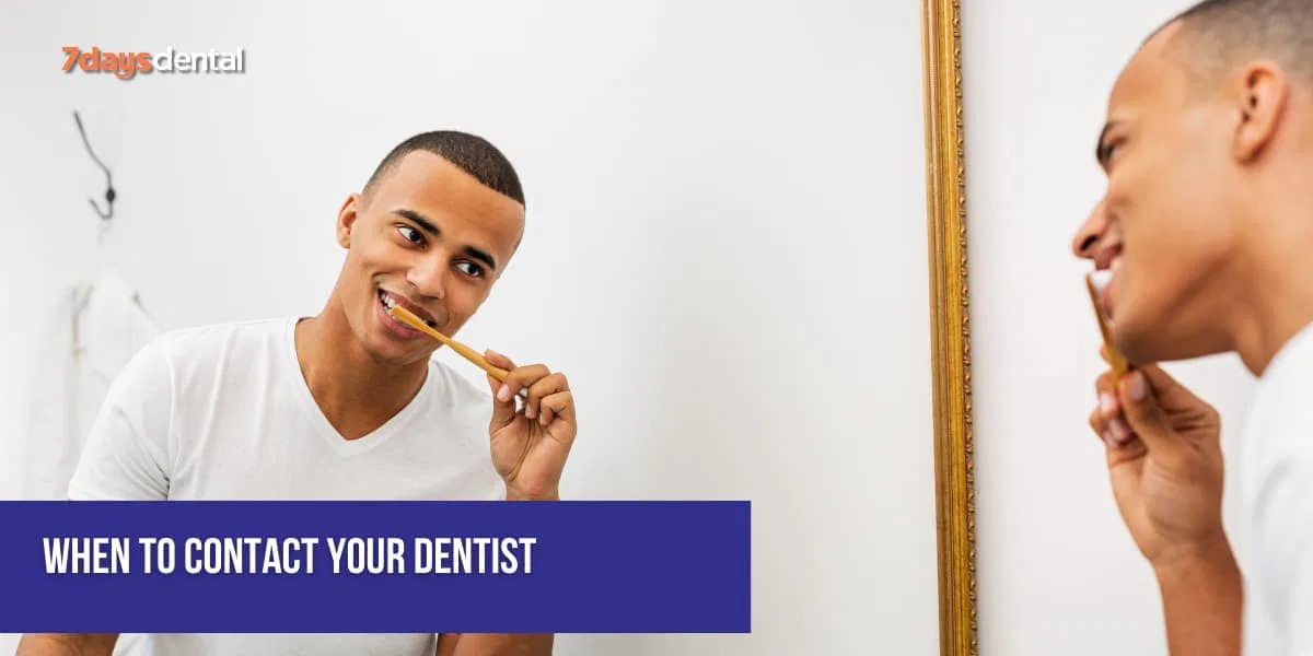 Smiling patient brushing teeth carefully after wisdom tooth surgery