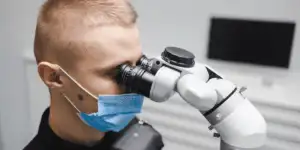 Periodontist using a dental machine